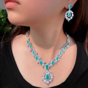 Model wearing a glamorous ice green pear-cut Cubic Zirconia necklace and earring set with pink and white accents.