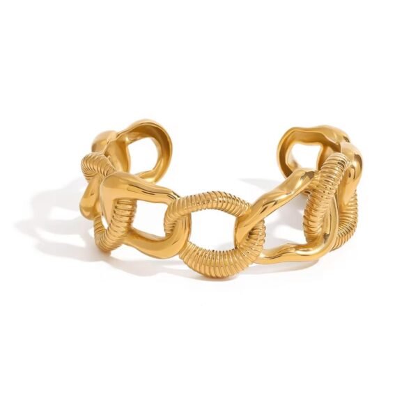 18K gold-plated twist-link cuff bracelet with a ribbed texture and open design on a white background.
